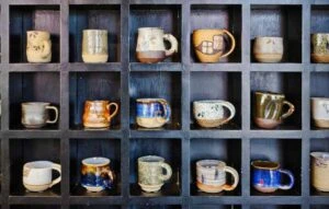 lots of mugs on a shelf made easy to reach with organizing