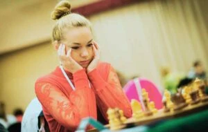 woman looking stressed about making decision at chess game