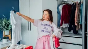woman purging clothes from closet