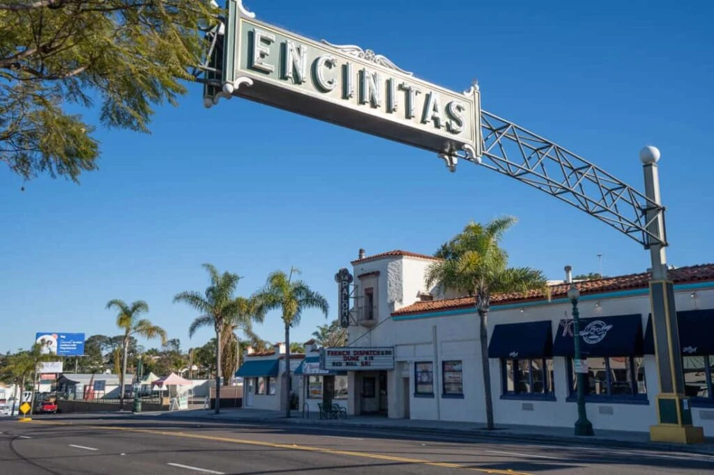A view of the iconic Encinitas sign surrounded by palm trees and classic architecture, representing Professional Organizing Services in Encinitas, CA.
