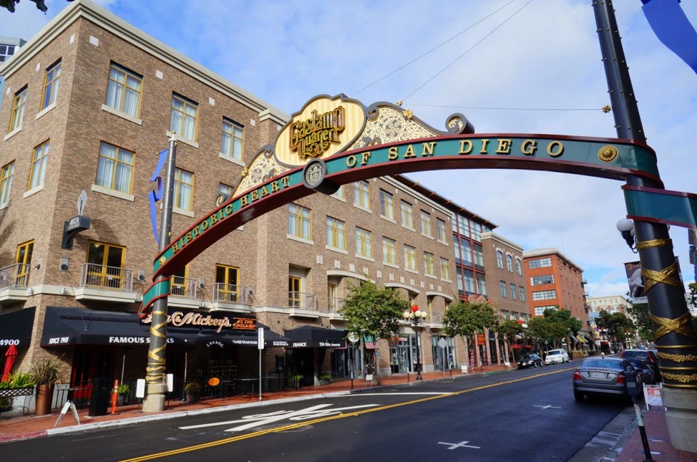 Historic Gaslamp Quarter sign in Downtown San Diego, surrounded by brick buildings and bustling streets