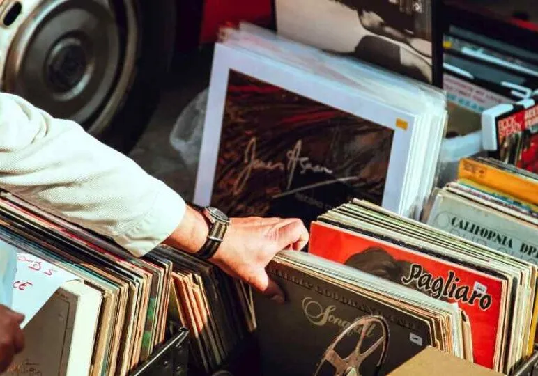 organizing piles of records as a part of decluttering project